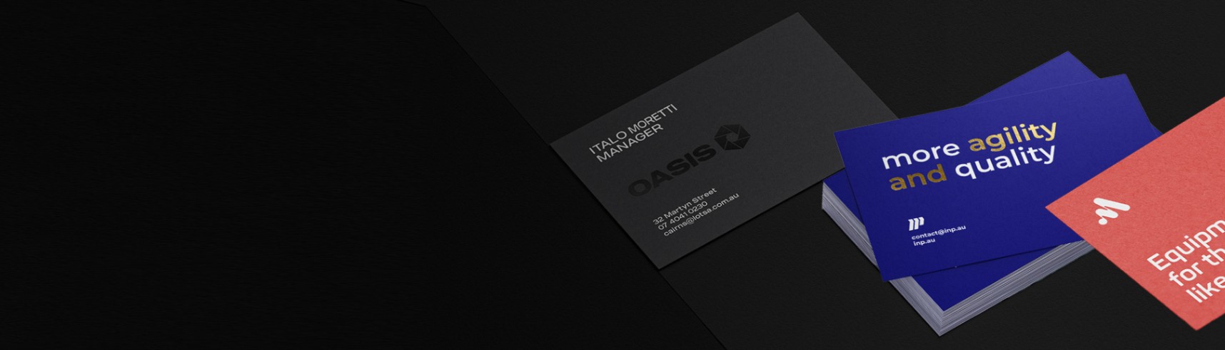 Assorted business cards on a black background with different finishes